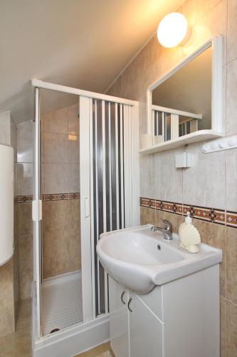 a bathroom with a sink and a shower at Apartments Junior in Zlatibor