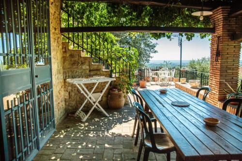 a wooden table and chairs on a patio at Borgo alle Mura in Casale Marittimo