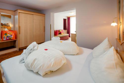 a bedroom with two white pillows on a bed at Kinderhotel Laderhof in Ladis