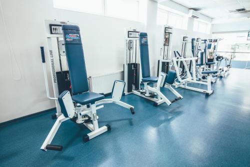 a row of treadmills and chairs in a gym at Zinedine Sport-Hotel in Uzhhorod