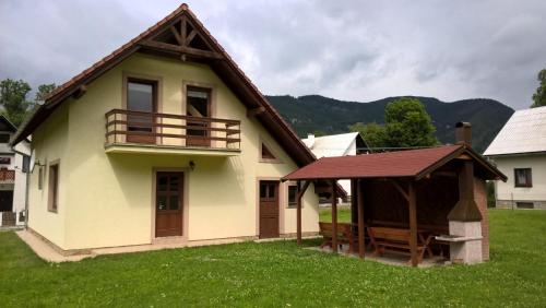 a small house with a porch and a balcony at Chata Monika in Prosiek