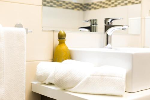 a bathroom with a sink and towels on a counter at Casa Ana in Zadar