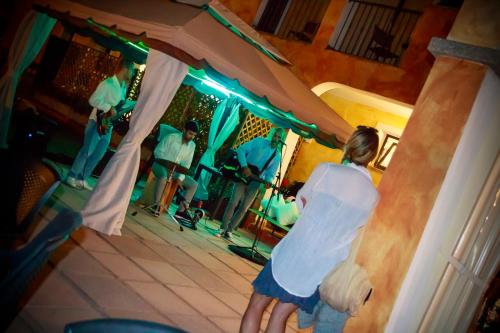 a woman is standing in front of a mirror at Abbaidda Hotel in Valledoria