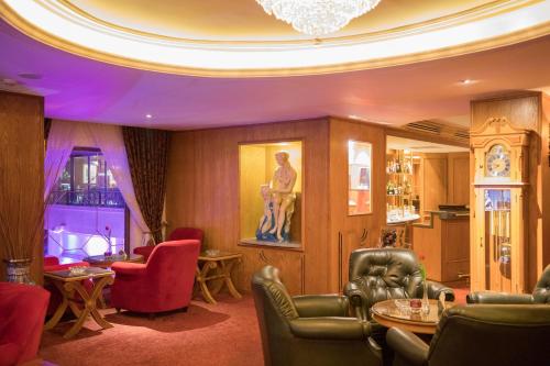a living room filled with furniture and a chandelier at Amman International Hotel in Amman