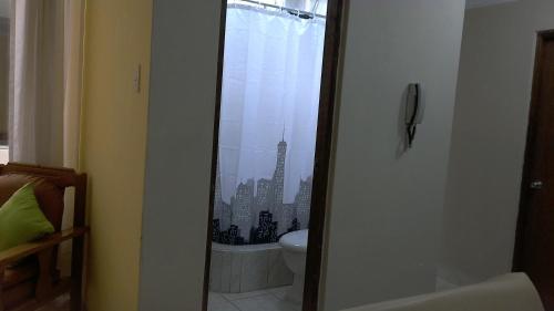 a bathroom with a toilet and a view of a city at Hospedaje de Lidia in Lima