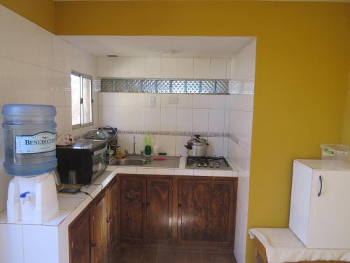a kitchen with a sink and a counter top at La Casa de José in San Pedro de Atacama