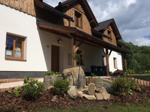 a house with a wooden roof at Penzion Terezka in Králíky