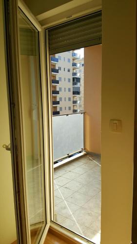 a sliding glass door with a view of a balcony at Zebra in Podgorica