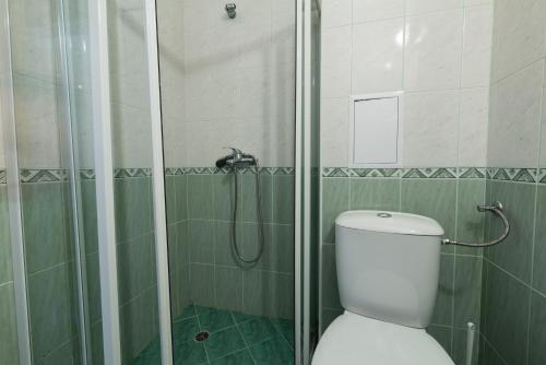 a bathroom with a shower with a toilet and a glass shower at Family Hotel Dayana Beach in Sinemorets