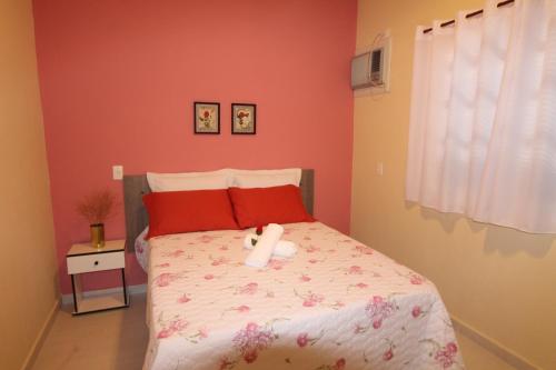 a bedroom with a bed with a teddy bear on it at Pousada Porto Paraiso, o seu Paraíso Escondido no Guarujá in Guarujá