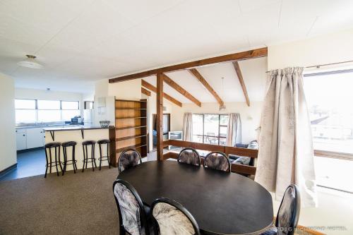a dining room with a black table and chairs at Richmond Motel and Holiday Park in Richmond