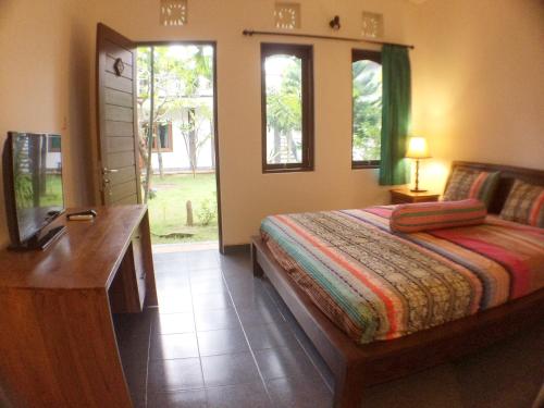 Postel nebo postele na pokoji v ubytování Ayu Guest House