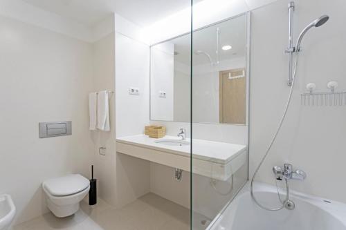 a bathroom with a toilet and a sink and a shower at Jasmineiro II by An Island Apart in Funchal
