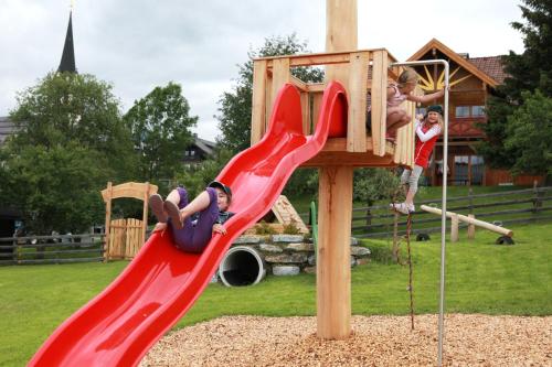 a group of children playing on a playground at Familien-Appartements Örglwirt's Gut in Mariapfarr