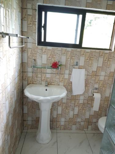 a bathroom with a white sink and a window at Horizon view in Victoria