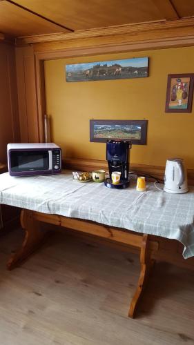 a counter with a microwave on top of a table at Gästehaus Krone in Schönengrund