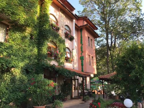 a building with plants and flowers on a street at Oleander House and Tennis Club in Sunny Beach