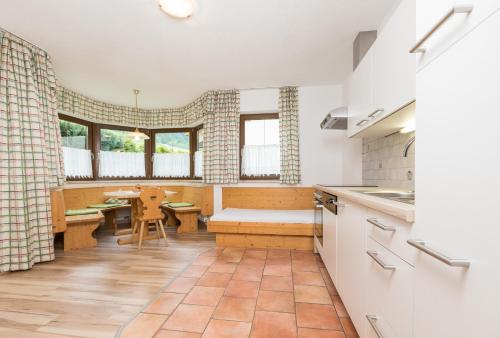 a kitchen with a table and a dining room at Apart&Chalet Chiara in Neustift im Stubaital