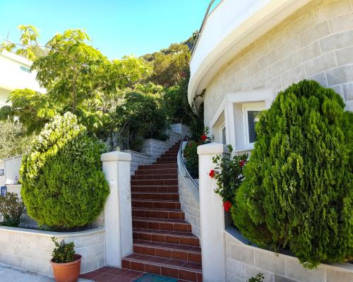 a set of stairs leading up to a house at Apartments Livia in Lastovo