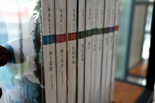 a group of books sitting on a shelf at SHANGHAI-DECO Hotel-Free shuttle bus to Pudong Airport and Disneyland in Shanghai