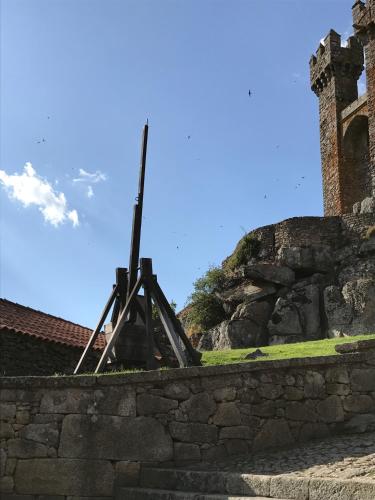 a wooden cross sitting on top of a stone wall at Hotel Medieval® de Penedono in Penedono