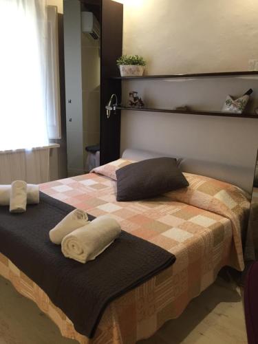 a bedroom with a bed with two towels on it at Duomo Residence Florence in Florence