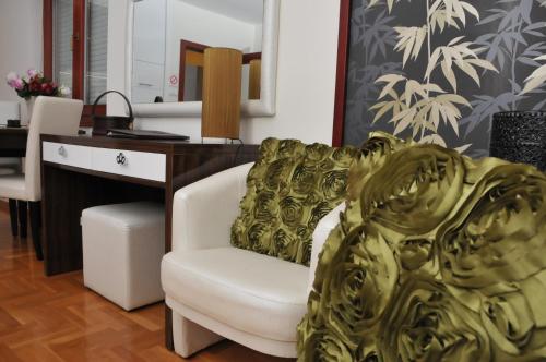a office with a desk and a chair with a gold blanket at Apartments Biser in Vrnjačka Banja