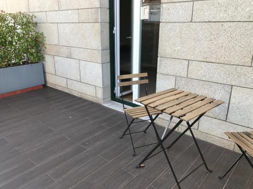 a wooden bench sitting outside of a building at Hotel Medieval® de Penedono in Penedono