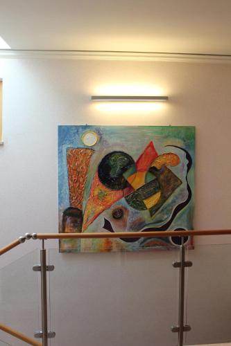 a painting hanging on a wall in a room at Hotel Al Sole - ENJOY HOLIDAY in Cavaion Veronese
