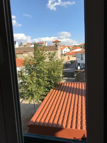 a view of a tile roof from a window at Hotel Medieval® de Penedono in Penedono