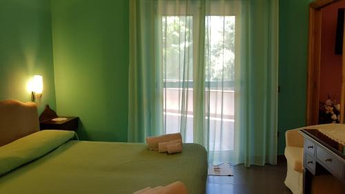 En eller flere senge i et værelse på Casa Del Sole