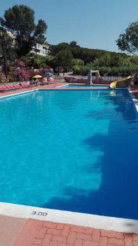 a large swimming pool with blue water at Villaggio Costa d'Argento in San Vito Chietino