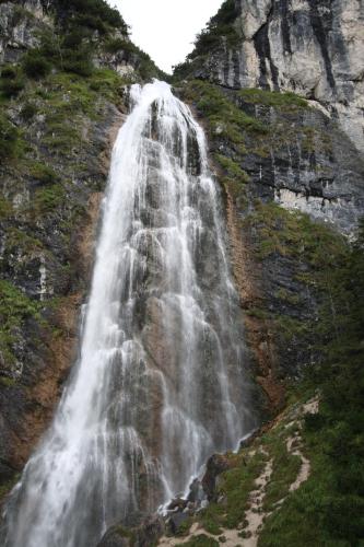 a waterfall on the side of a mountain at Appartements Rofangarten in Maurach