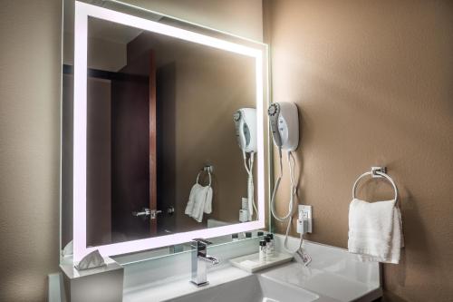 a bathroom with a sink with a mirror and a phone at Skyline Hotel and Casino in Las Vegas