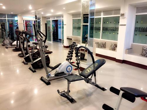 a gym with several cardio equipment in a building at Win Hotel Phayao in Phayao