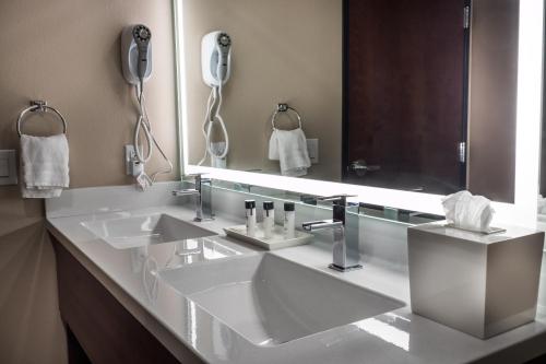 a bathroom with two sinks and a large mirror at Skyline Hotel and Casino in Las Vegas