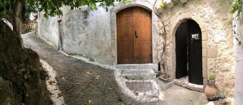 a stone building with a wooden door and stairs at Meronas Eco House in Méronas