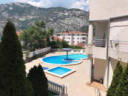 a view of a swimming pool from a building at Roman Garden Apartment in Risan