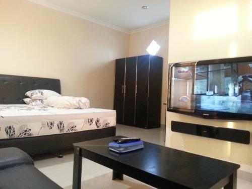 a living room with a bed and a coffee table at Discovery Homestay in Makassar