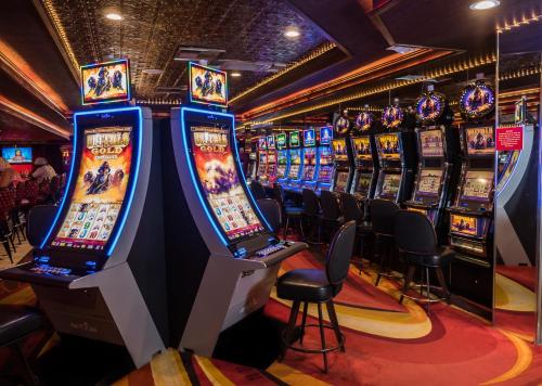 a bunch of slot machines in a casino at Skyline Hotel and Casino in Las Vegas