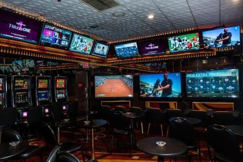 a room with many televisions and tables and chairs at Skyline Hotel and Casino in Las Vegas