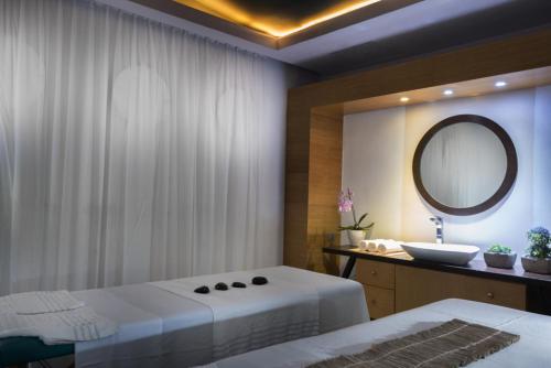 a bathroom with two beds and a mirror at Leonardo Hotel Jerusalem in Jerusalem