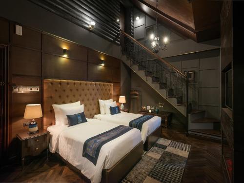 a bedroom with two beds and a staircase at Aliana Boutique Sapa Hotel & Spa in Sa Pa