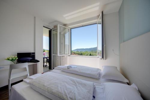 מיטה או מיטות בחדר ב-Residence Isolino