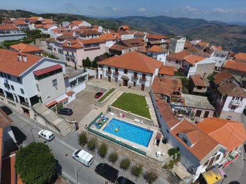 an aerial view of a town with a swimming pool at Casa Do Brasao in Tabuaço