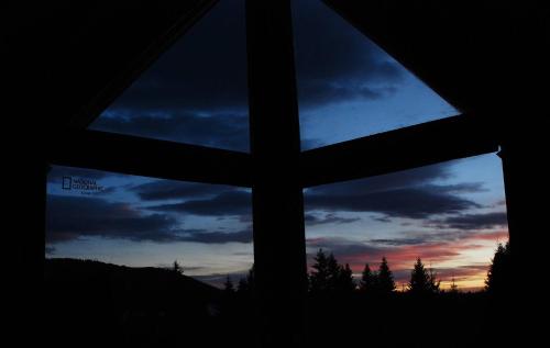 a view from a window of a sunset at Mountain bungalows and a Hobbit House - Jazavčije Rupe in Han Pijesak