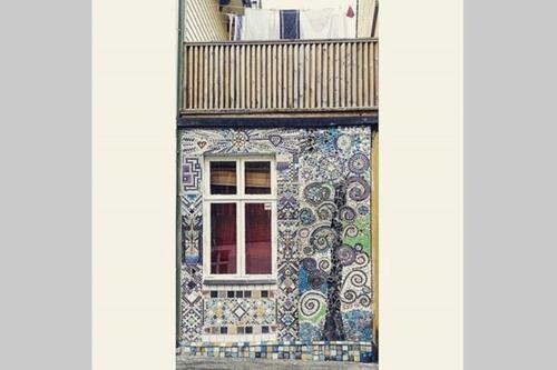 a building with a tiled facade with a window at Rongahuset BnB in Evanger