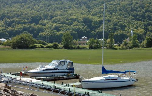 two boats are docked at a dock in the water at Auberge Le Four à Pain in Petite-Rivière-Saint-François