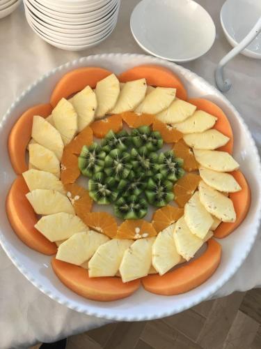 a plate of food with cheese and green onions at Hotel Lady Mary in Milano Marittima