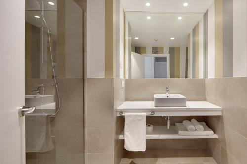 a bathroom with a sink and a mirror at Hotel Flysch in Zumaia
